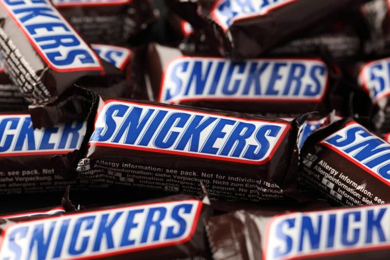 A collection of brown Snickers bars, with their labels clearly visible