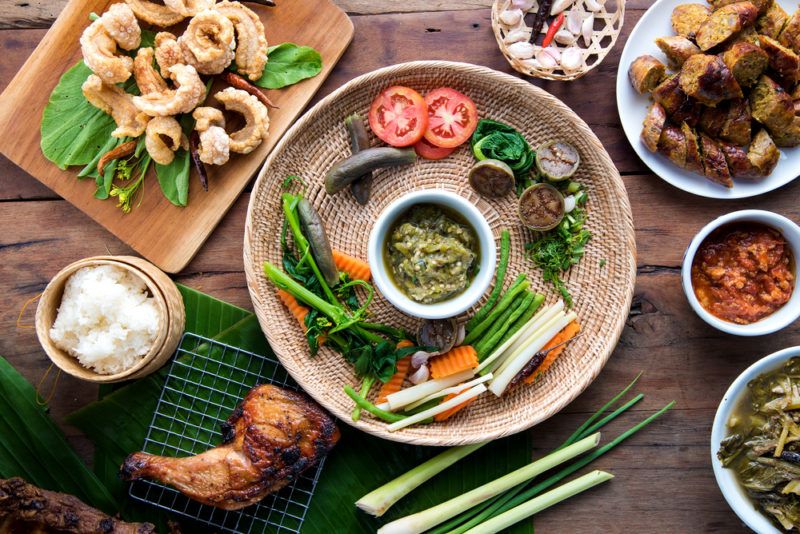 A selection of small Thai meals on a wooden table