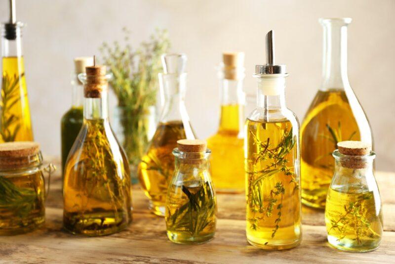 A selection of different bottles of infused olive oil on a table