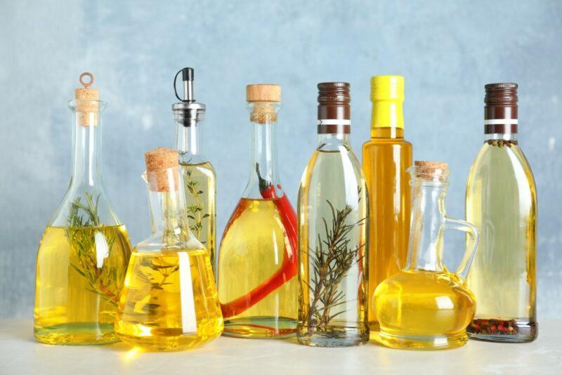 Bottles of different types of oil, including olive oil, canola oil, and more