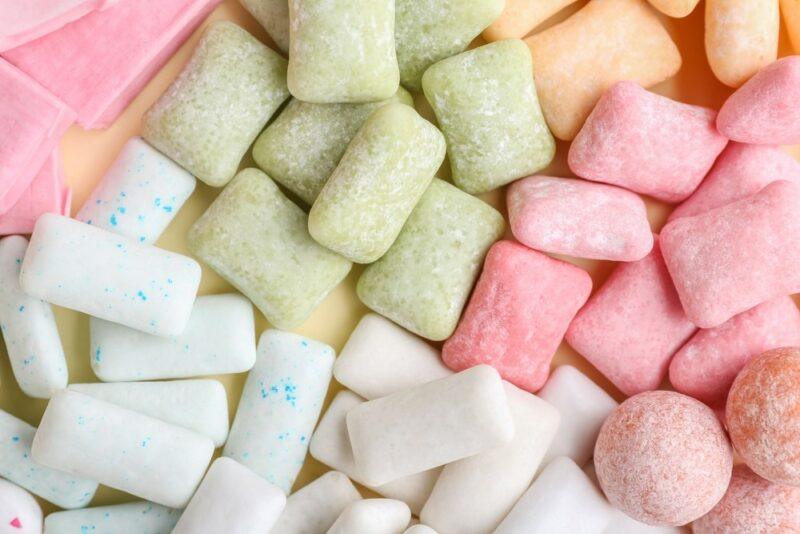 A selection of white, green, and pink chewing gum on a table