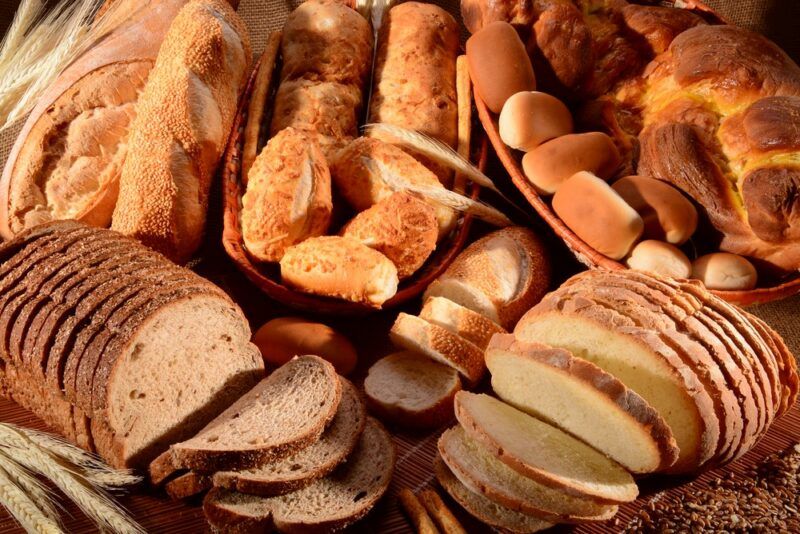 A pile of fresh bread of all shapes and sizes