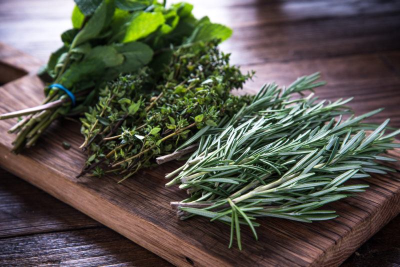 A selection of fresh herbs on a cutting board