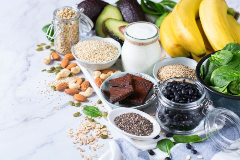 A selection of magnesium rich foods on a white table