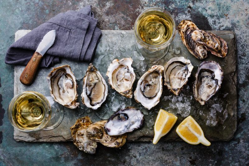 Half a dozen or so oysters opened on a table