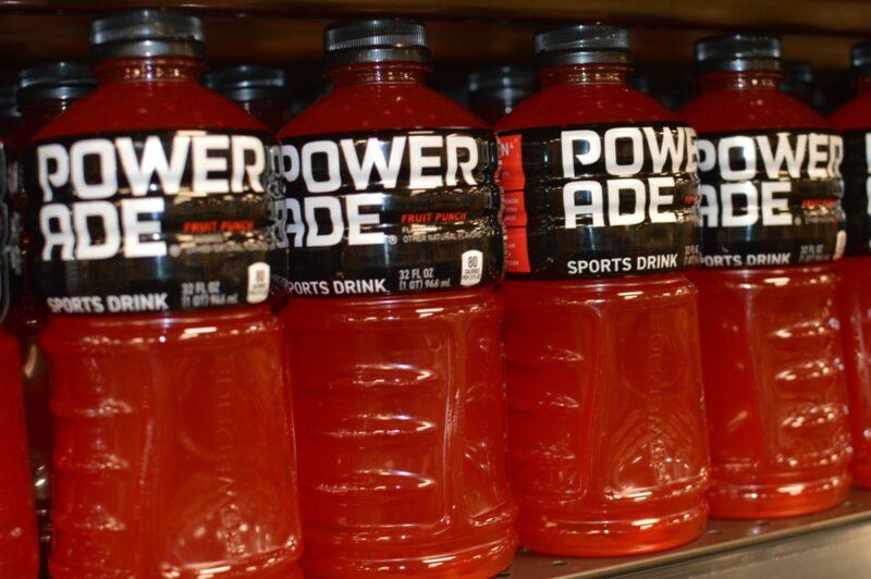 Bottles of orange or red Powerade in a grocery store