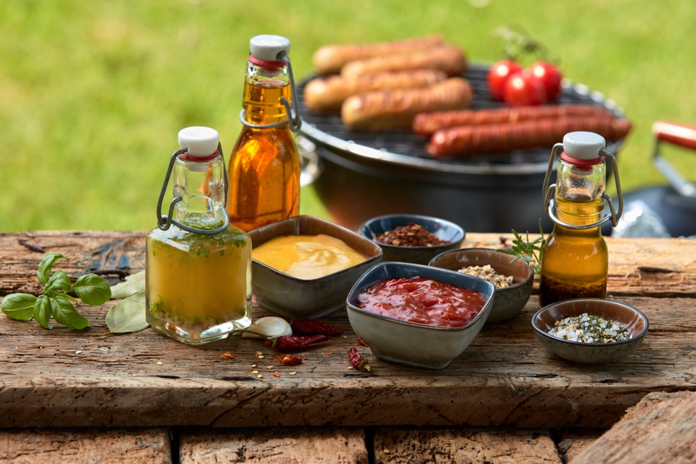 A board on an outside table with various spices and condiments