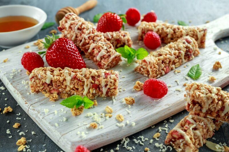 A board with a large selection of strawberry protein bars