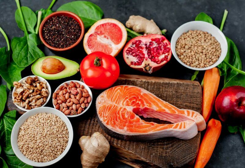 Grains, nuts, and seeds, along with salmon and fresh vegetables