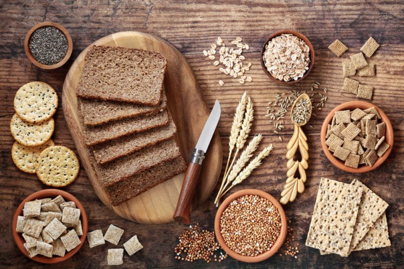 A flat lay of various whole grain foods, including bread and crackers