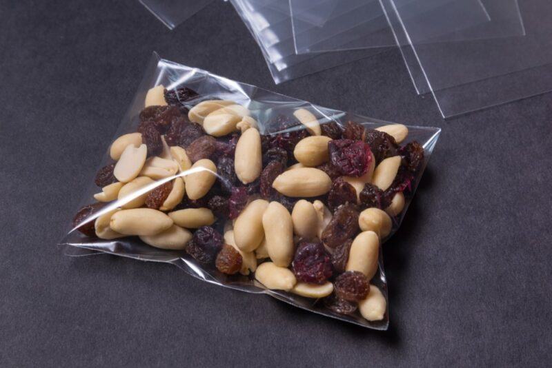 A plastic bag containing a peanut and raisin-based trail mix