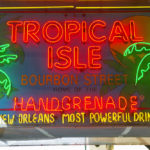 A sign in New Orleans advertising the handgrenade cocktail and Tropical Isle in neon lights