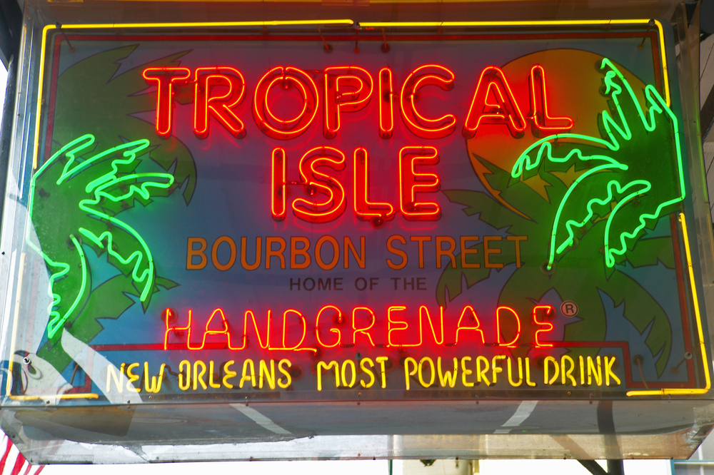 A sign in New Orleans advertising the handgrenade cocktail and Tropical Isle in neon lights