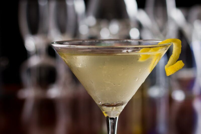 A close shot of a smoky martini with a lemon twist