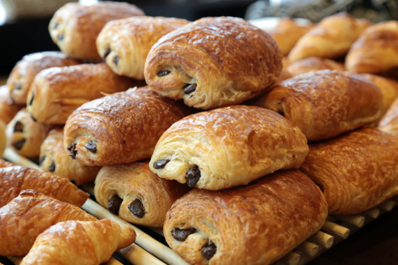 A stack of pain au chocolat in a bakery