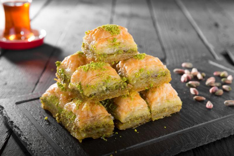 A black tray with macadamia nut baklava