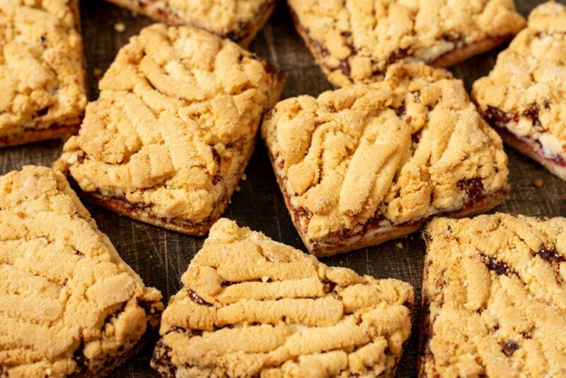 A wooden table with a stack of cookie dough bars