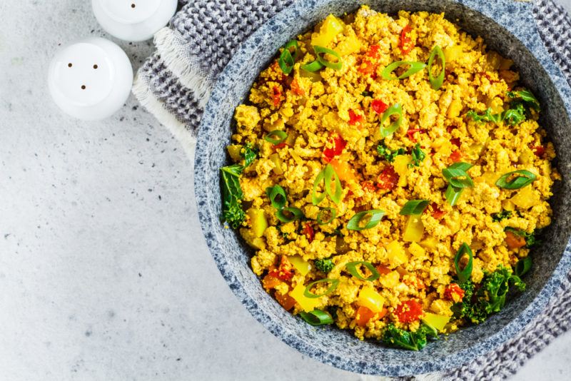 A ceramic bowl that contains tofu scramble