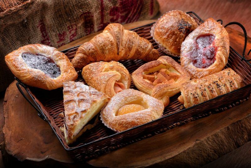 A tray filled with fresh pastries including danishes