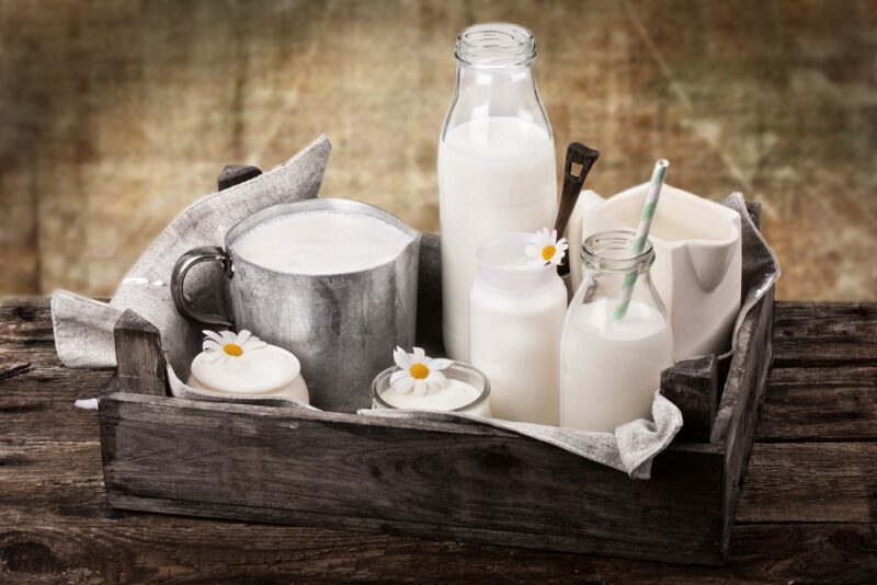 A wooden tray with a selection of different types of milk