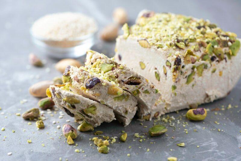 A vegan dessert that is topped with pistachio nuts