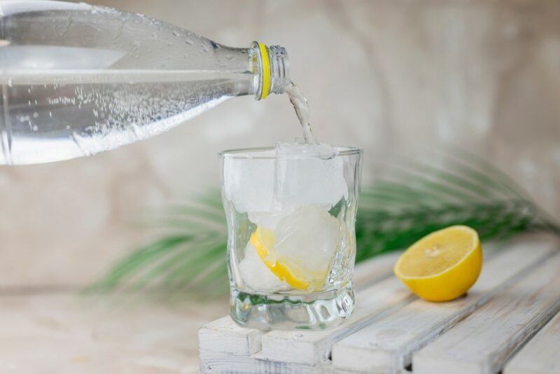 A homemade vodka lemonade cocktail, with soda being poured in