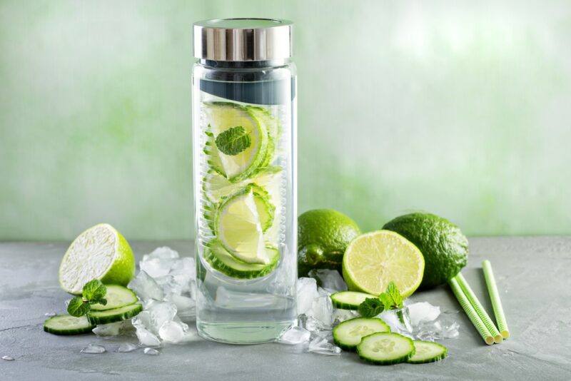 A water bottle filled with lime pieces, to make infused lime water