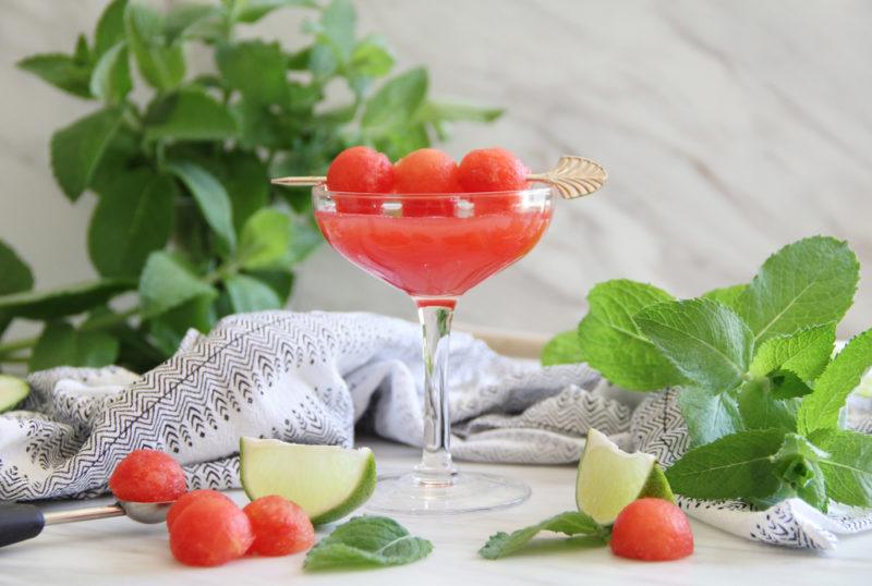 A watermelon cocktail that has been garnished with watermelon balls