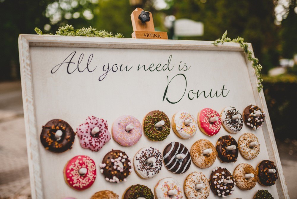 A large board with donuts hanging off pegs