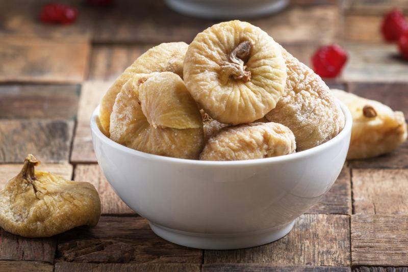 A white bowl with dried figs