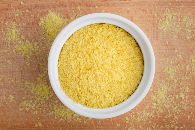 A white bowl of nutritional yeast