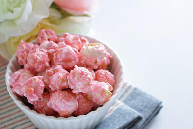 A white dish with white chocolate raspberry popcorn