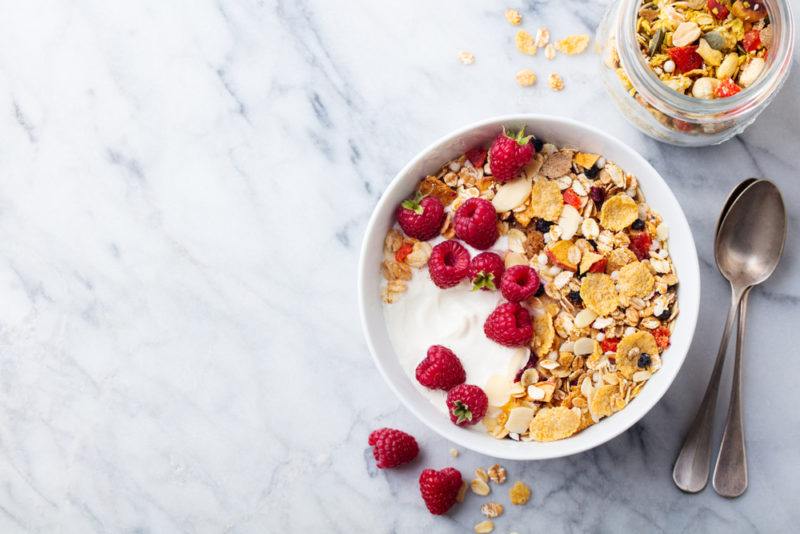 A bowl of cereal that can be found in France, along with milk and berries