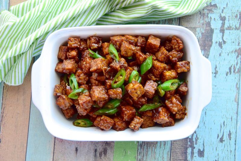 A white oblong dish that contains diced tempeh