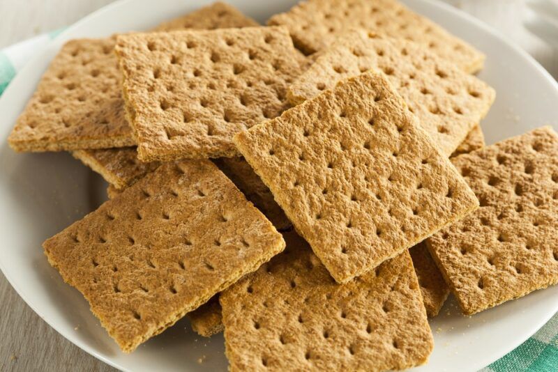 A pile of graham crackers on a white plate