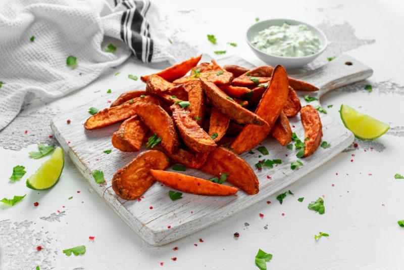 A white plate with sweet potato fries