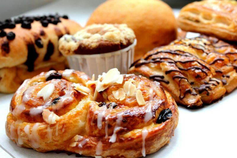 A collection of sweet fresh pastries on a white tray.