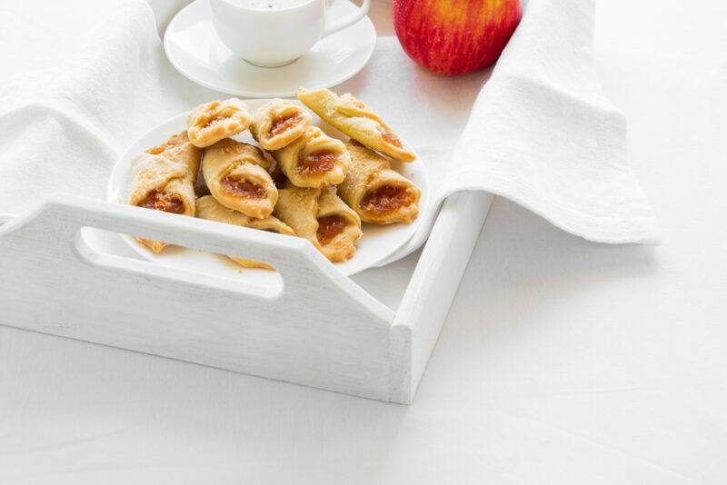 A white tray with a white dish of kolaczhi