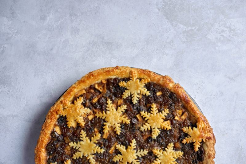 A winter fruit pie with snowflakes made out of pastry