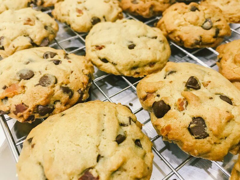 A wire baking frame with a collection of bacon and chocolate cookies