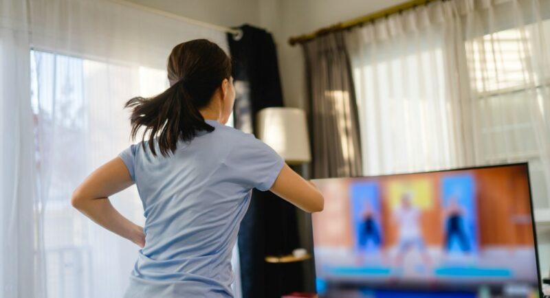 A woman working out indoors using a fitness program