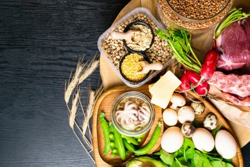 A wooden board that contains many types of fresh zinc rich foods