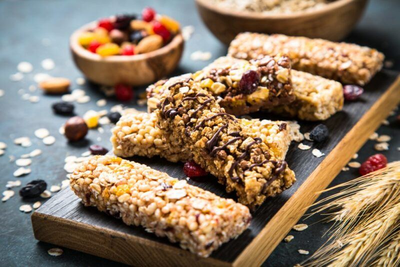 A wooden board with different types of homemade protein bars on top