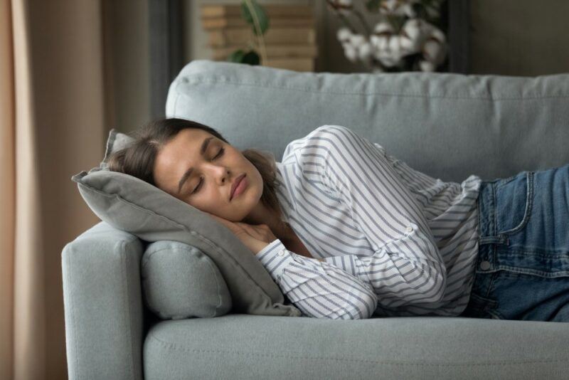 A young woman gently sleeping in the lounge