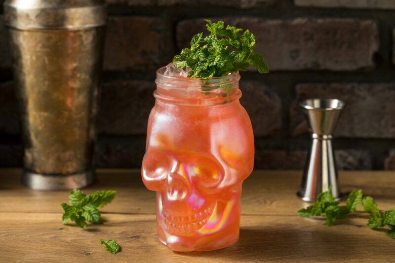 A glass shaped like a skull containing a zombie cocktail