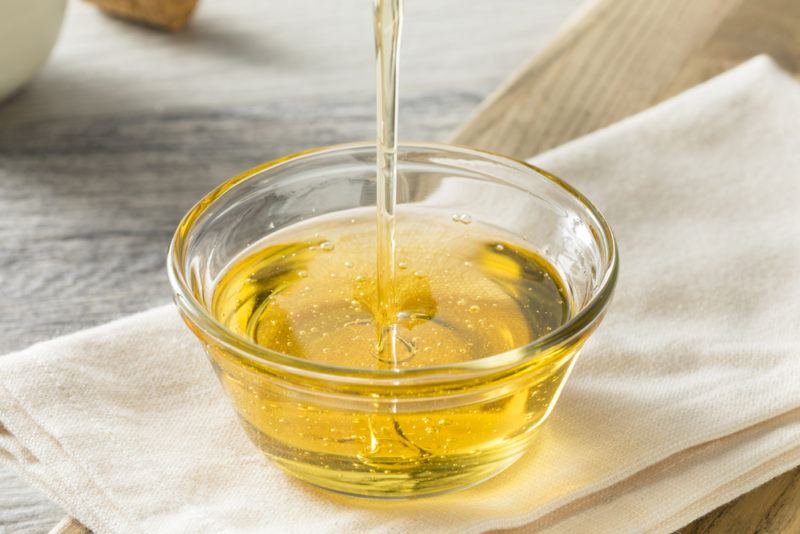 Agave syrup being poured into a small glass dish