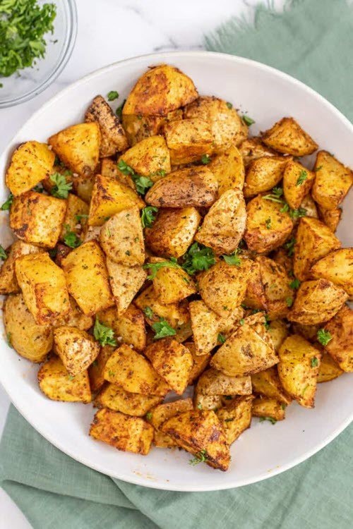 A large white dish containing healthy air fryer breakfast potatoes