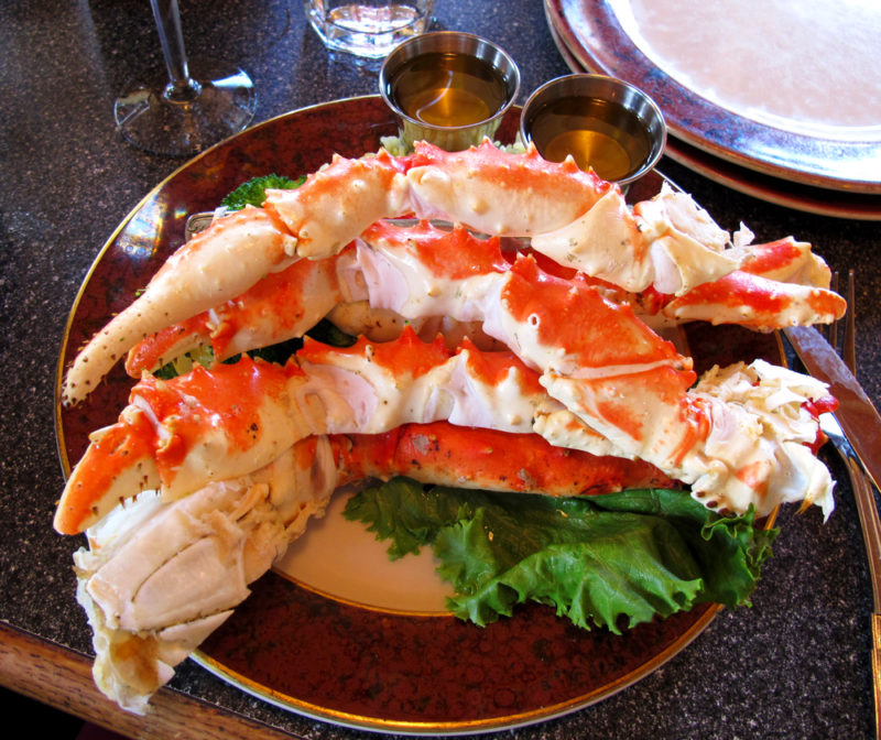 A brown plate with cooked Alaskan king crab legs