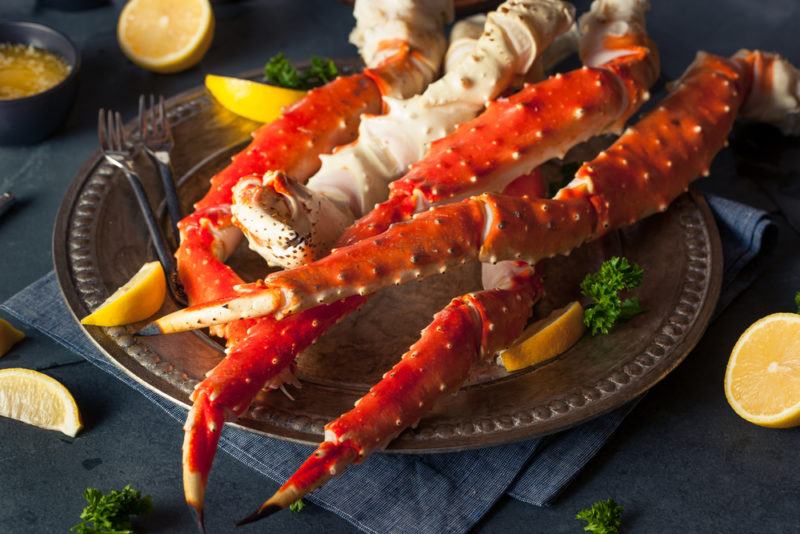 A black plate with fresh Alaskan king crab legs