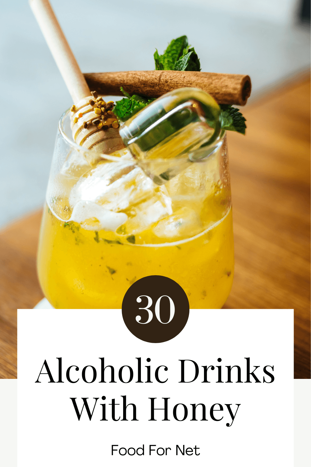 A single glass on a wooden table, containing a honey cocktail, highlighting alcoholic drinks made with honey